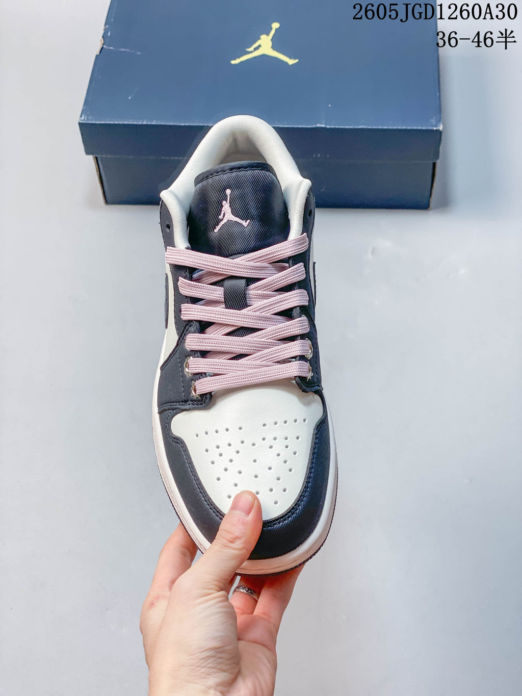 Front view of the perforated toe and pink-laced upper
