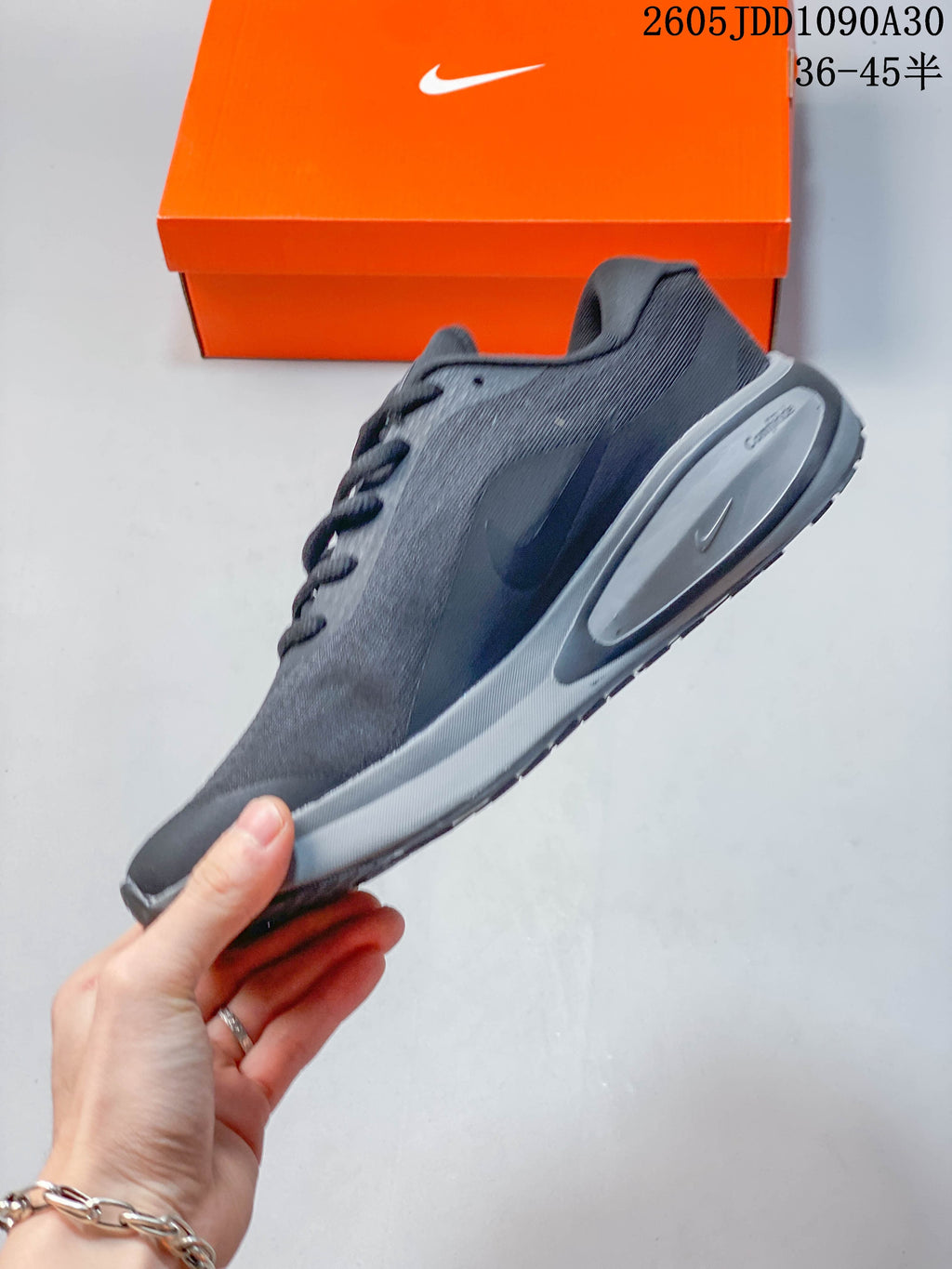 Side profile of a dark gray Nike Journey Run shoe with a sculpted midsole.