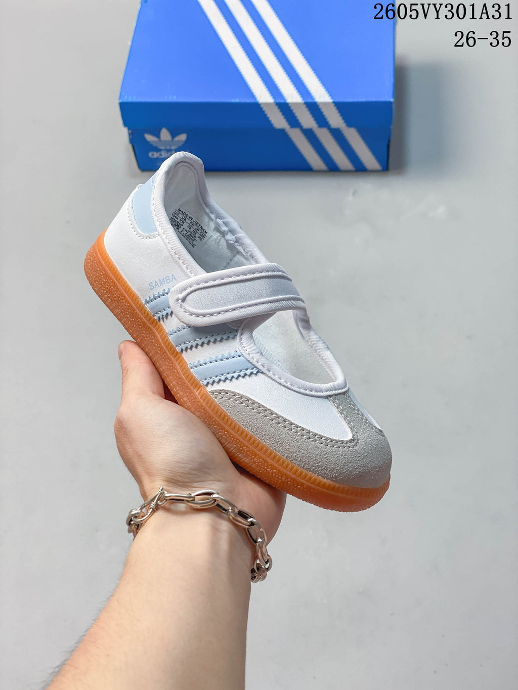 White and pale blue kids’ Samba Jane shoe with gray toe detail