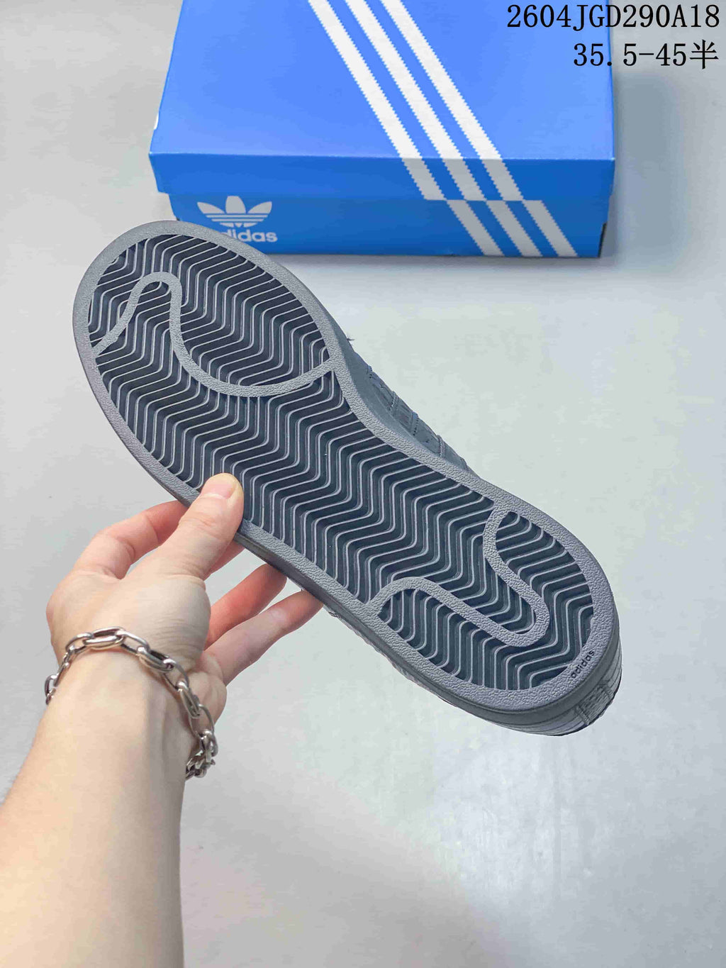 Close-up of the patterned outsole on a black Adidas Originals Superstar 2 sneaker