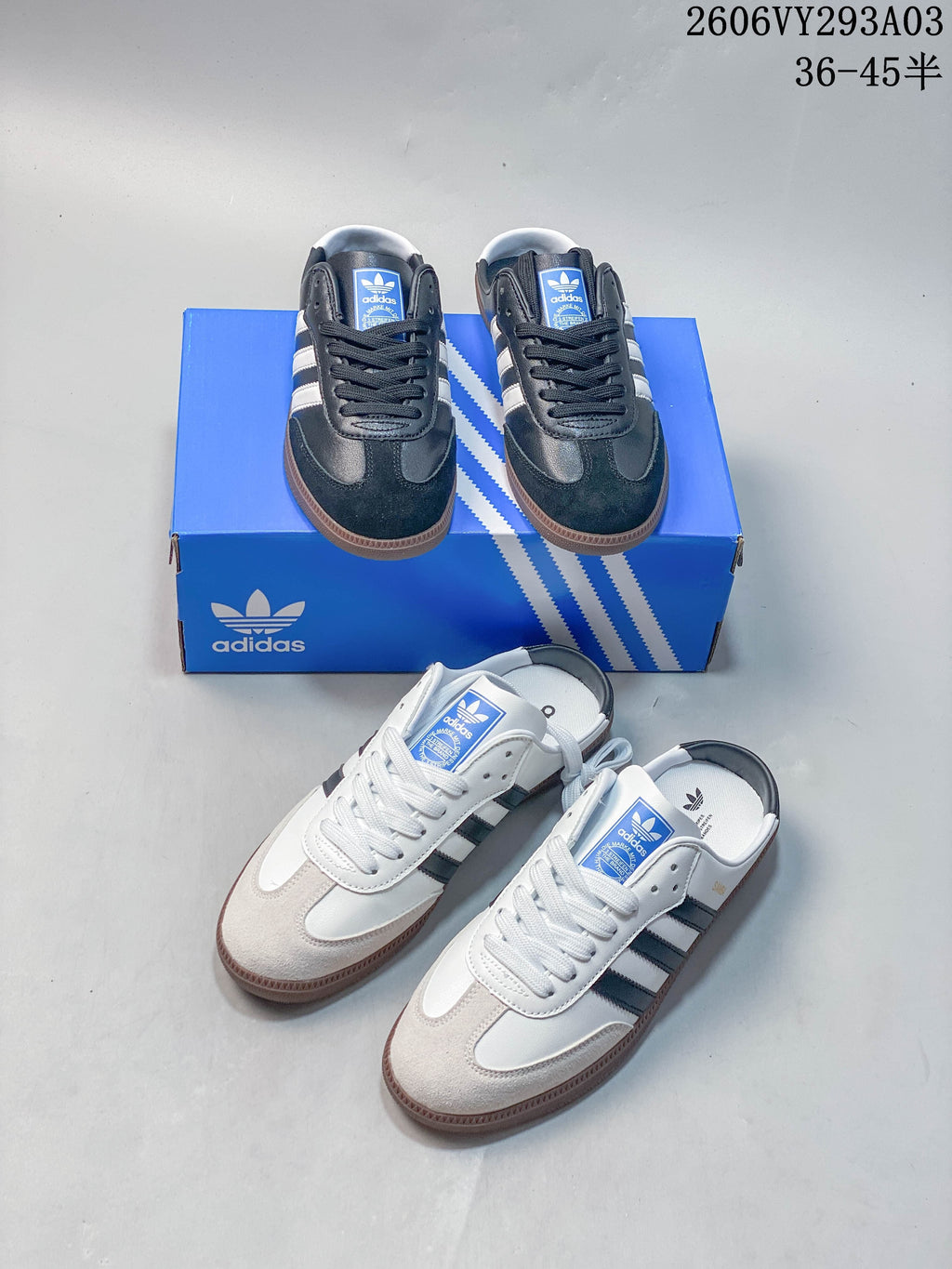 Navy and white Adidas low-top sneakers shown together with a blue shoe box.