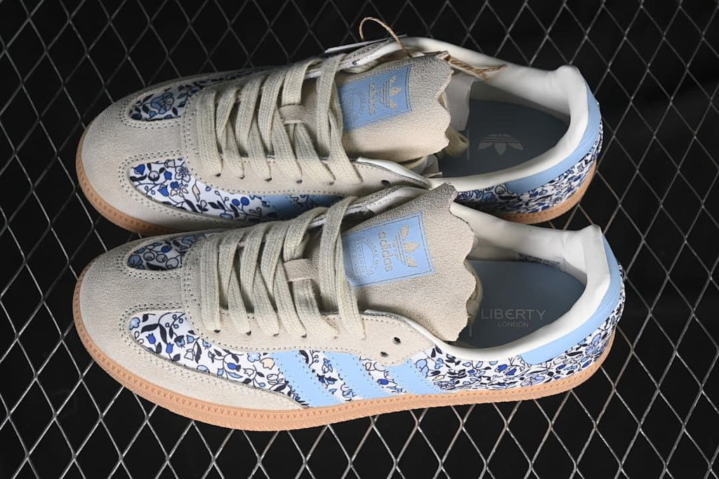 Pair of adidas Samba OG sneakers viewed from above, showing the floral pattern and blue accents