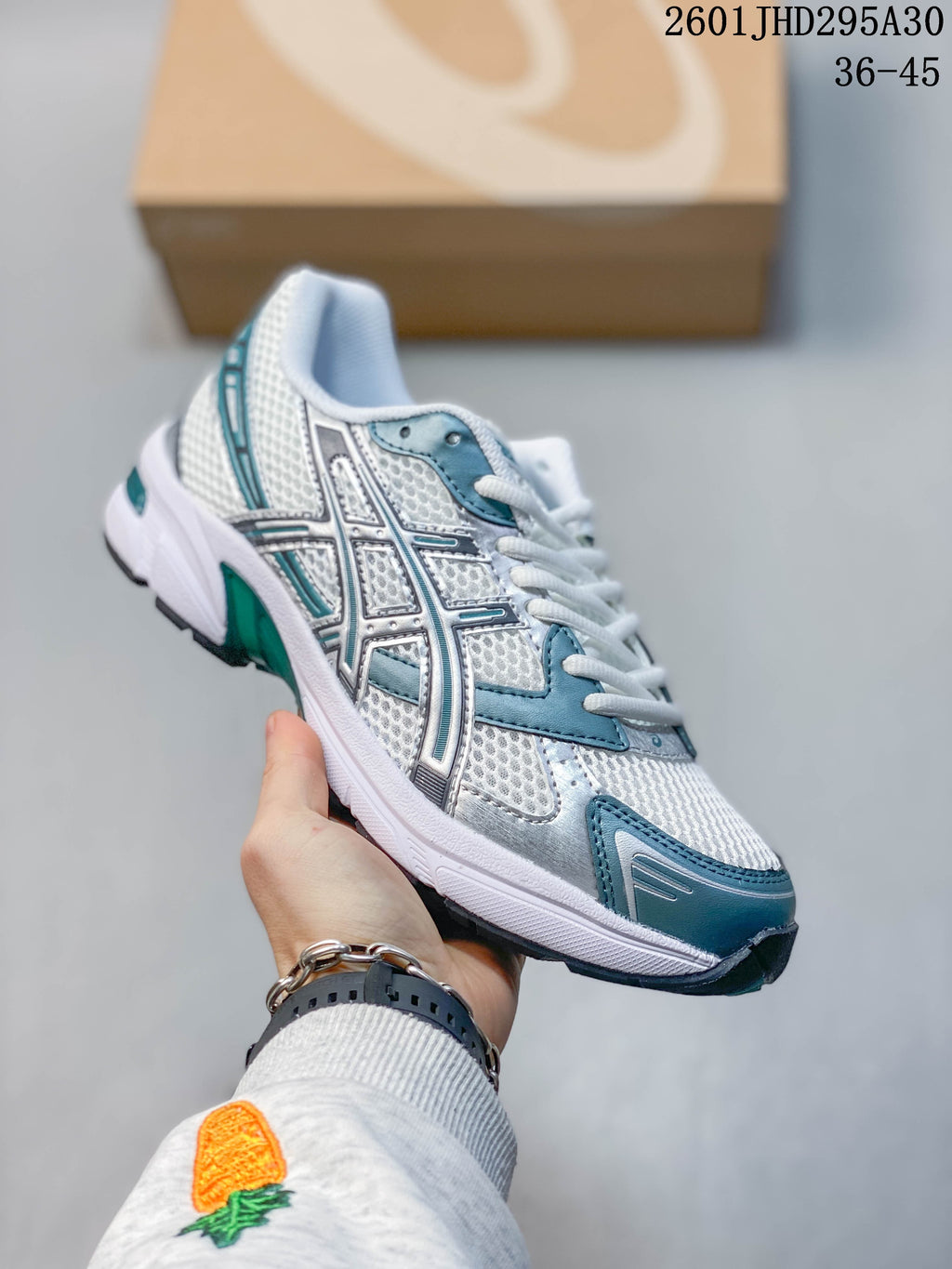 Close side view of the ASICS logo and layered upper