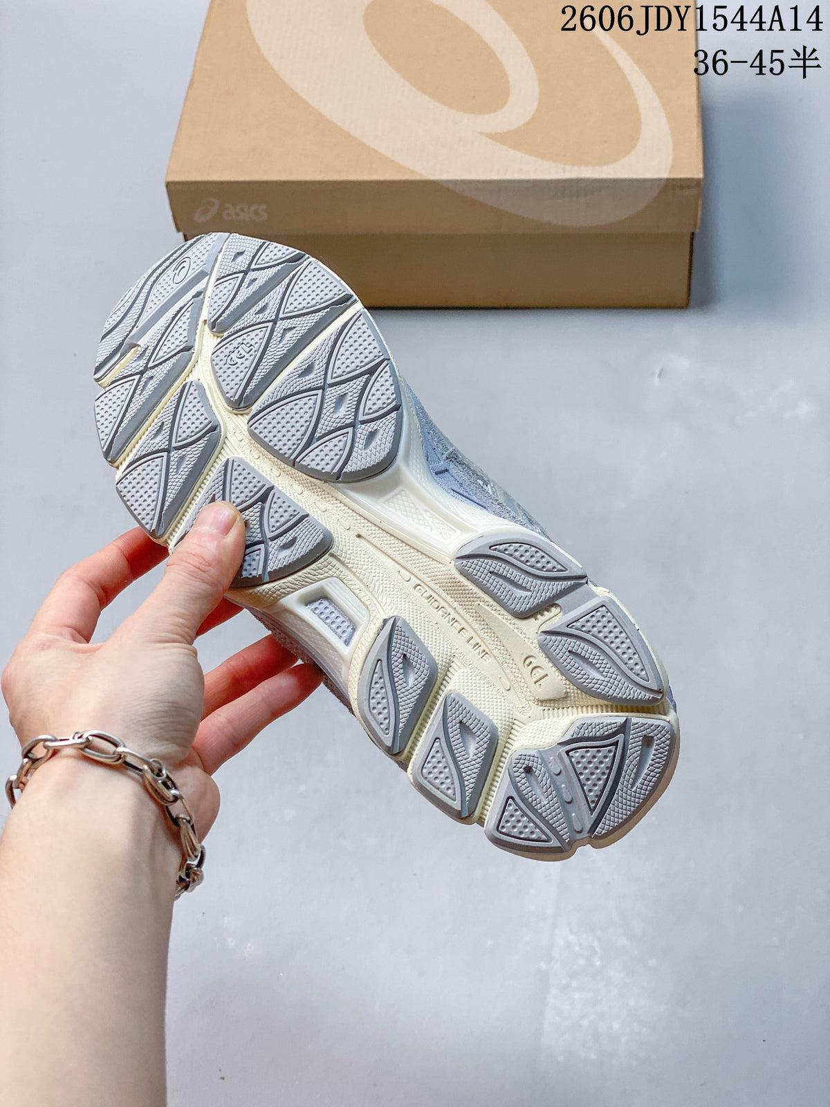 Close view of the sneaker outsole showing segmented grey tread and a light-colored midsole.