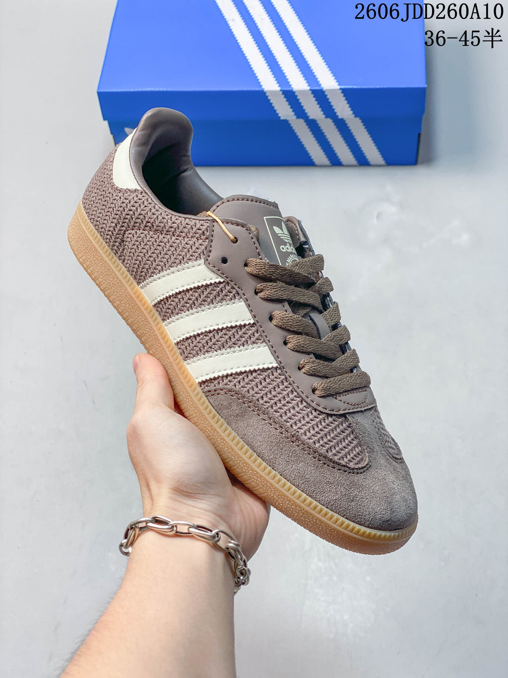 Side view of a brown Samba OG sneaker with off-white stripes and a gum-colored outsole