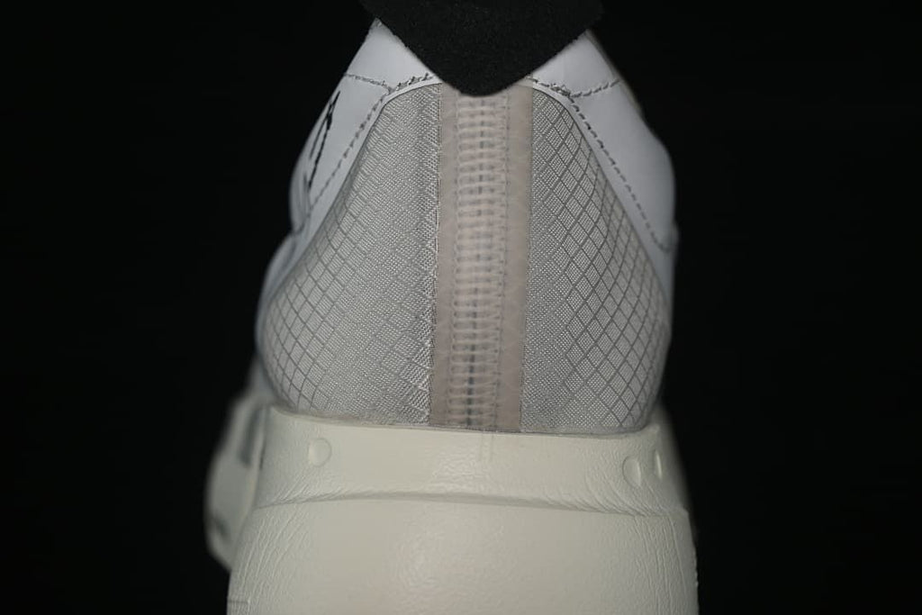Rear view of the shoe showing the patterned heel and thick off-white sole