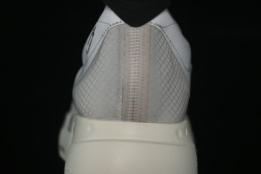 Rear view of the shoe showing the patterned heel and thick off-white sole