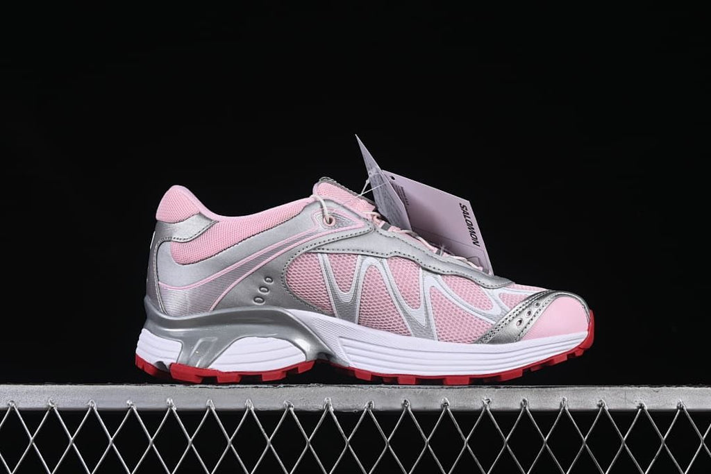 Side profile of a pink and silver-tone sneaker