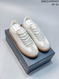 Pair of white and light gray ECCO lace-up sneakers with gum-colored soles, shown on a branded box