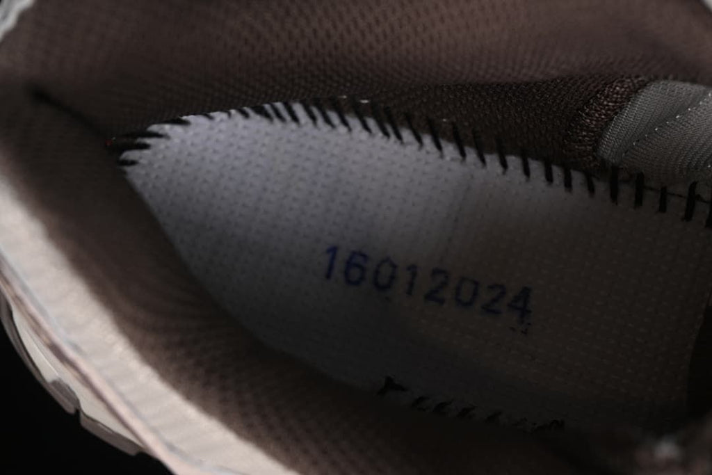 Close-up inside the shoe showing a printed production code