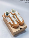 Pair of brown and white DESCENTE Chron Velo low-top sneakers displayed on a shoebox
