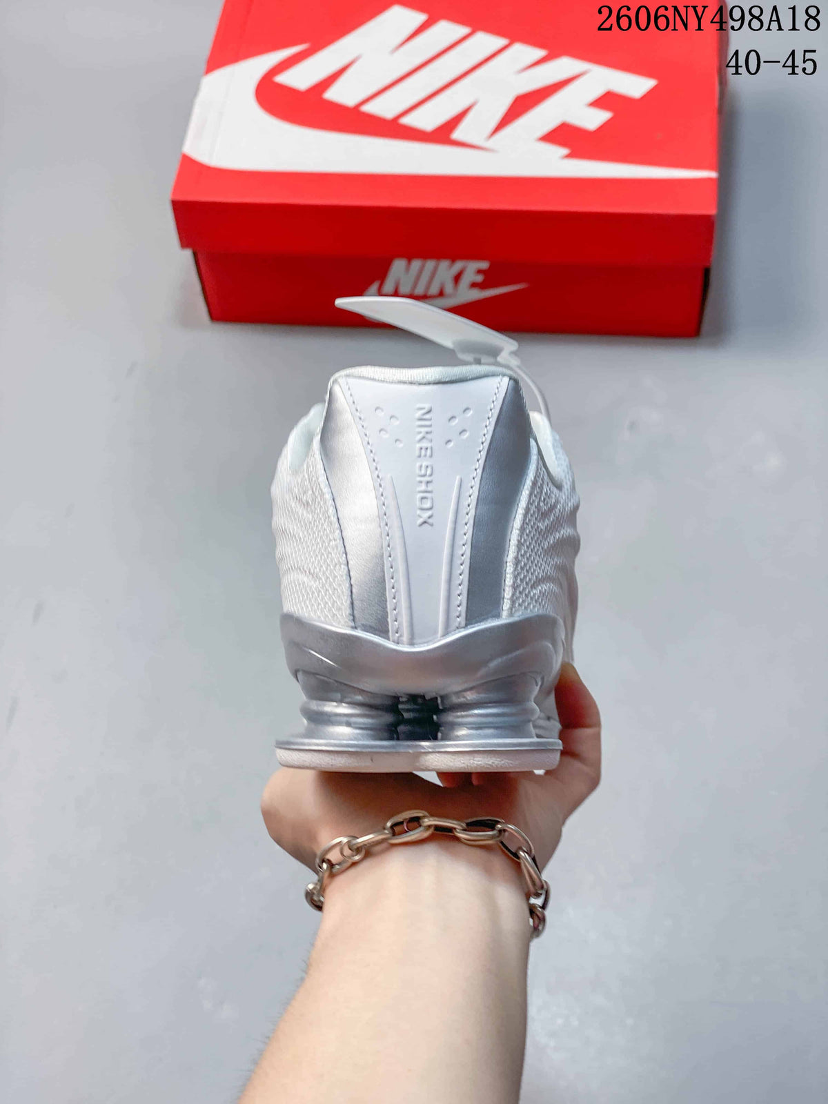 Rear view showing the sneaker's heel structure and Shox columns