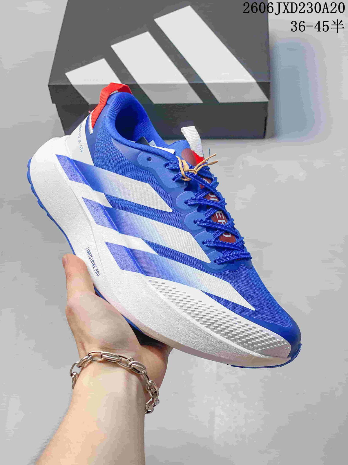 Side view of a blue, white, and red Adidas Adizero Evo SL running shoe