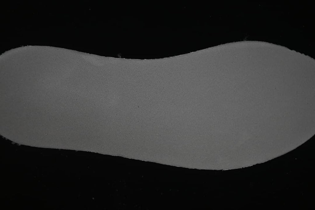 Close-up view of the shoe's dark gray sole or footbed surface