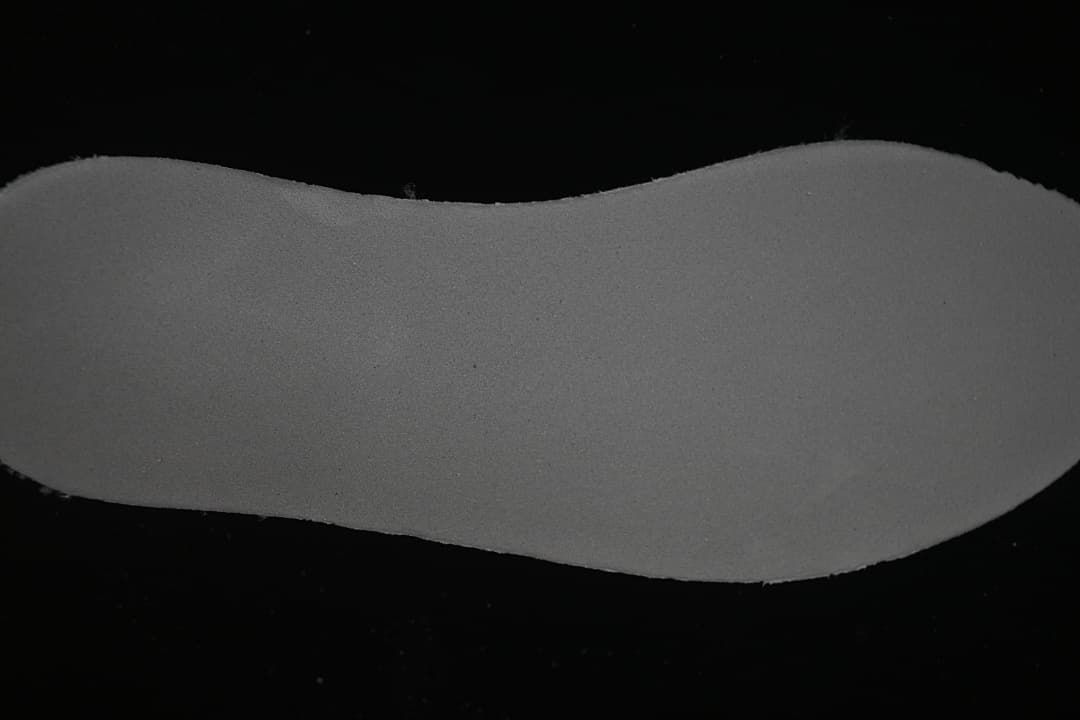 Close-up view of the shoe's dark gray sole or footbed surface