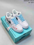 Pair of white Nike Court Vision Low DIY sneakers with blue laces and colorful accents