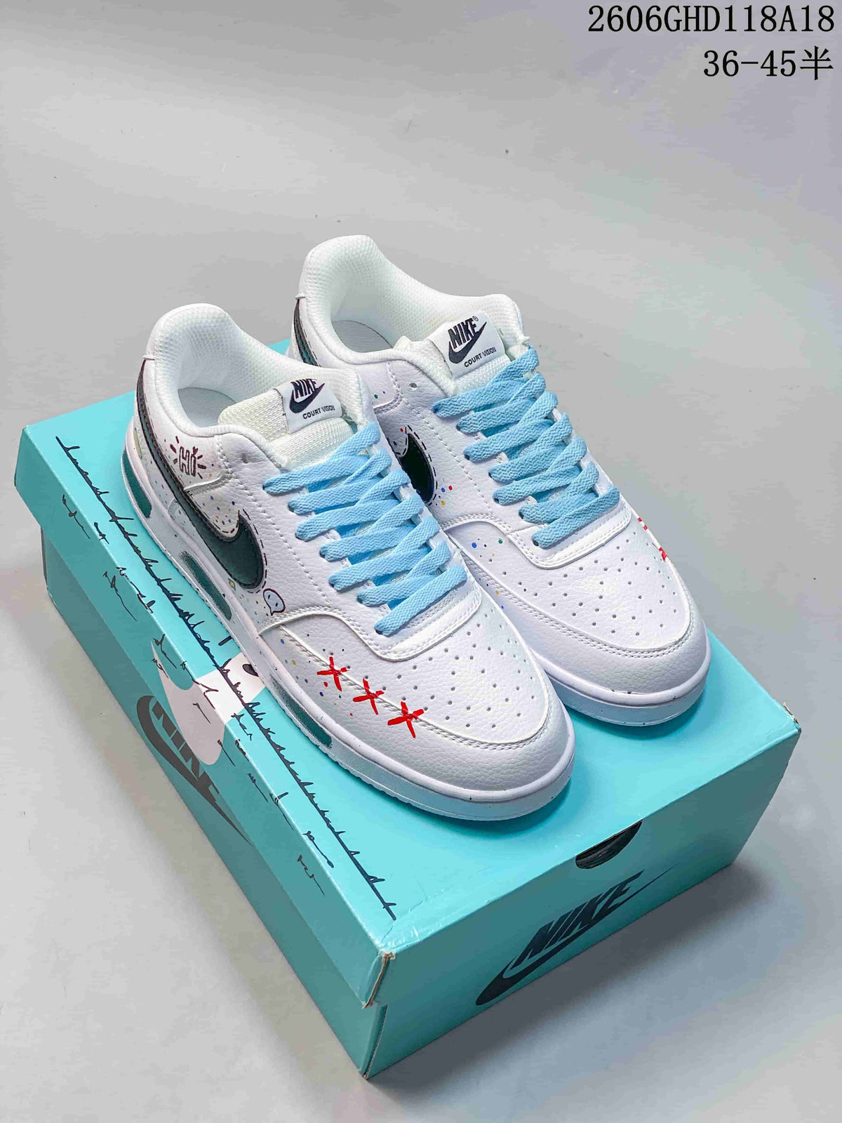 Pair of white Nike Court Vision Low DIY sneakers with blue laces and colorful accents