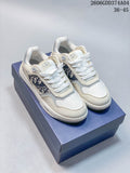 Pair of white low-top sneakers with patterned side panels, shown on a blue box