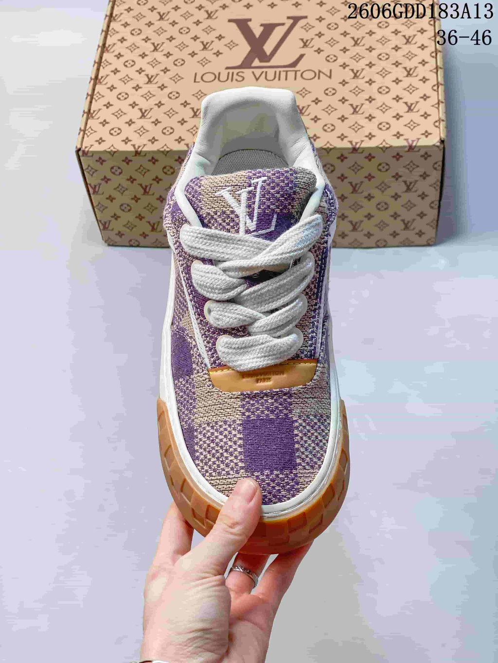 Front view highlighting the check-patterned upper, white laces, and tan toe accents