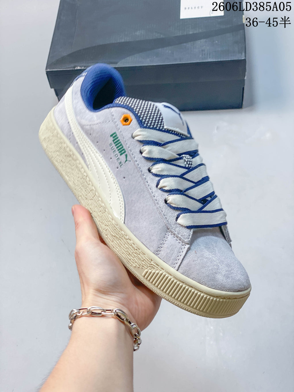 Angled side view highlighting the gray upper, PUMA branding, and cream-colored sole