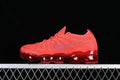 Side view of red Nike Air VaporMax 2023 Flyknit sneakers with a translucent red sole