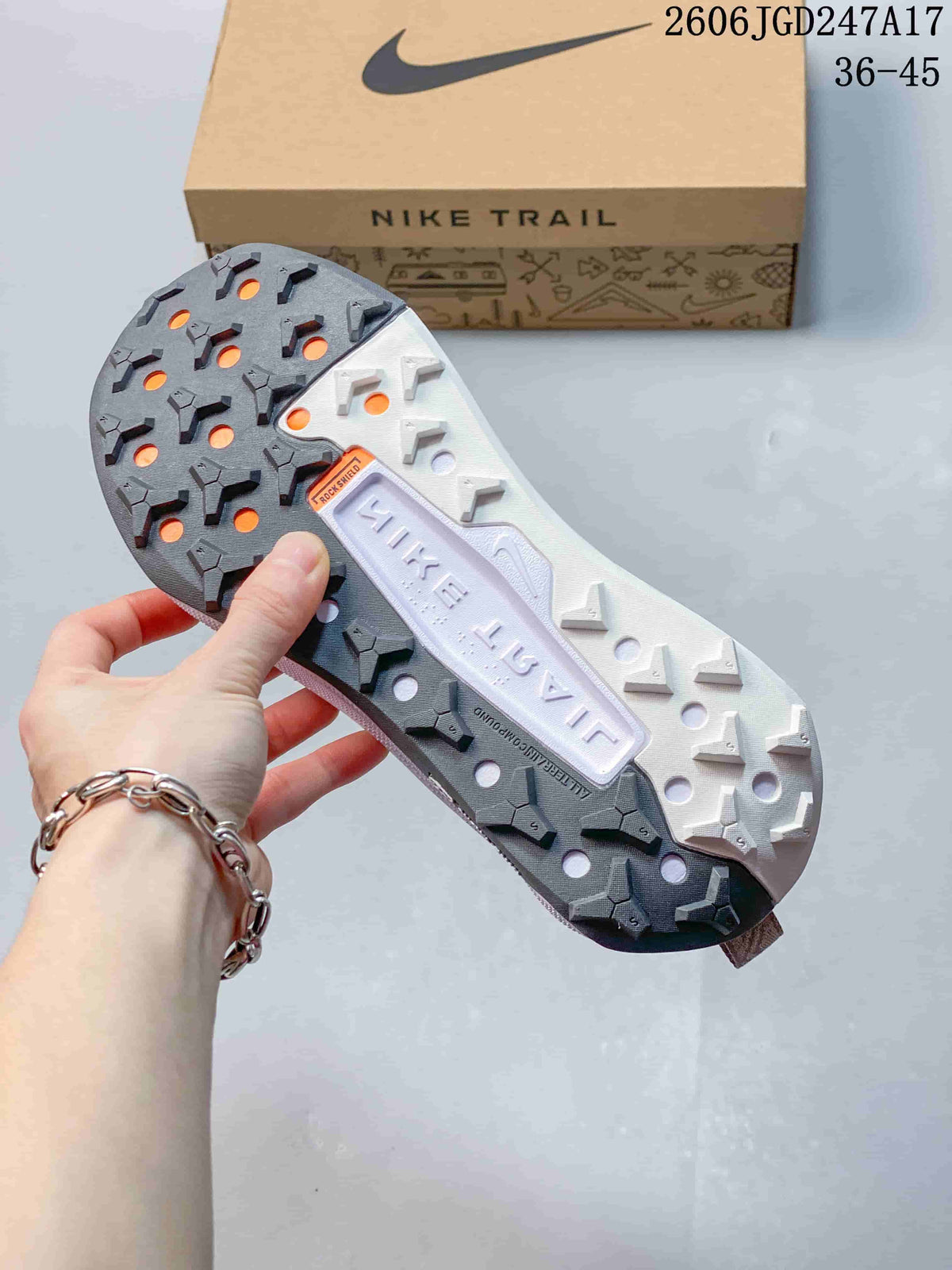 Close-up of the Nike Wildhorse 10 lugged outsole, with the Nike Trail box in the background