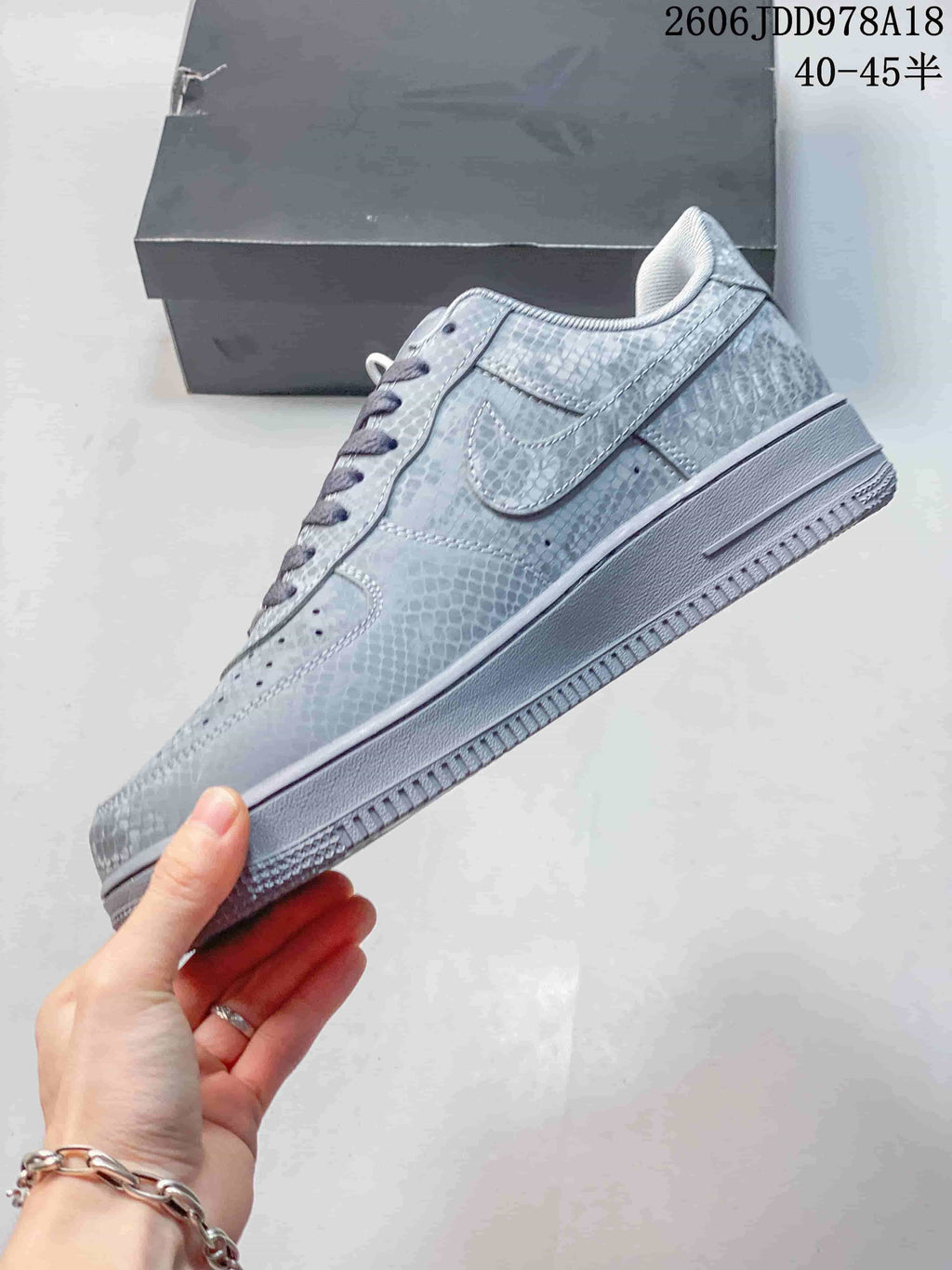 Side profile of a gray patterned low-top sneaker