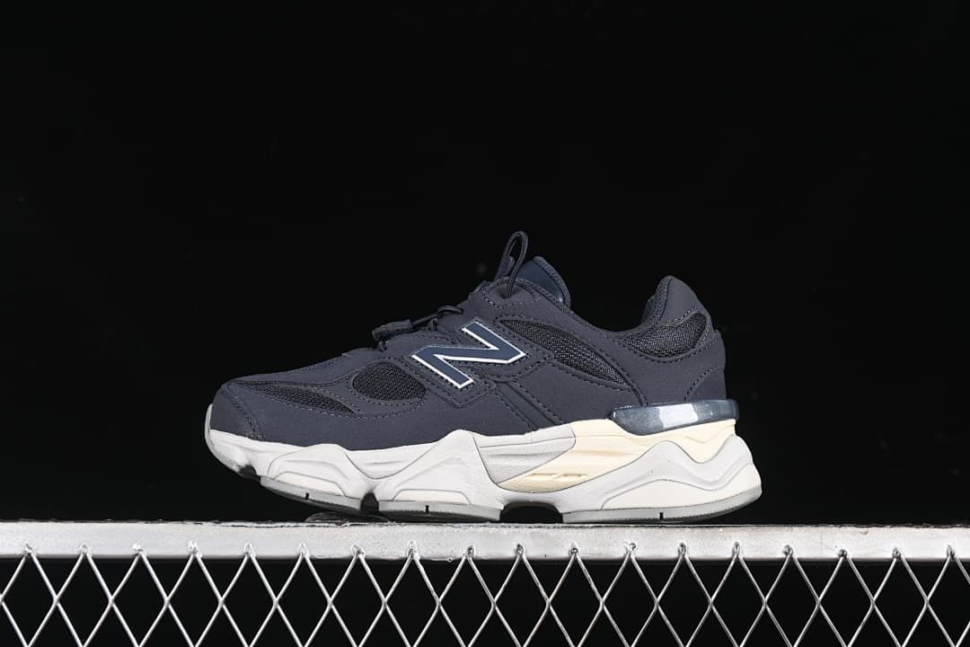 Side view of a navy New Balance kids’ sneaker