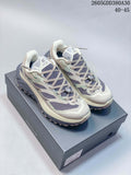Pair of light-colored Kailas C4 trail running shoes on a shoebox
