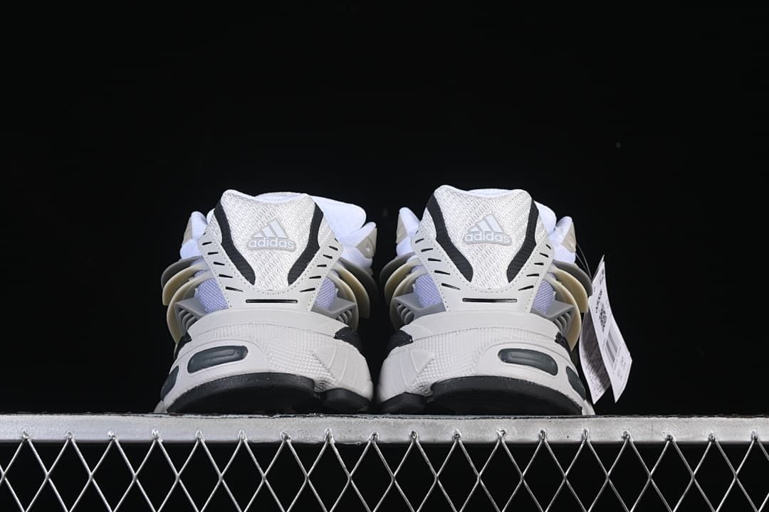 Rear view of both sneakers showing the heel panels and sole