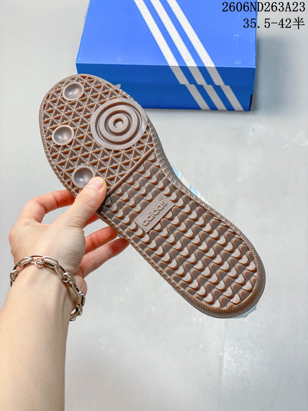 View of the brown patterned outsole on a light blue Adidas Samba Jane sneaker