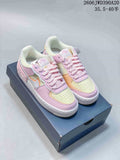 Pair of pastel pink, pale yellow, peach, and white Nike Air Force 1 low-top sneakers on a shoebox.