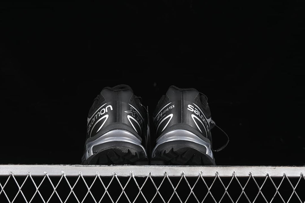 Rear view of both shoes showing the heels and lugged outsole edges.