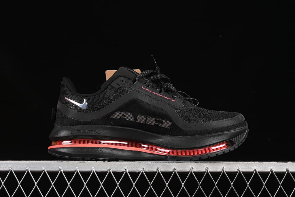 Lateral profile showing the black upper, silver Swoosh and coral cushioning unit