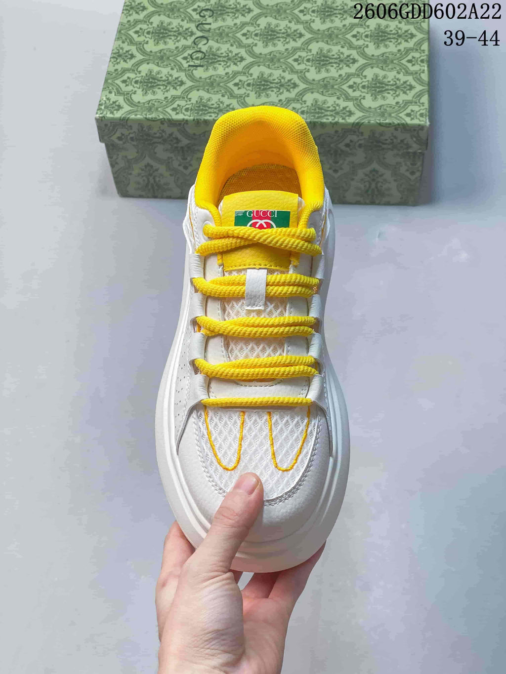 Top view showing yellow laces and collar on the white sneaker