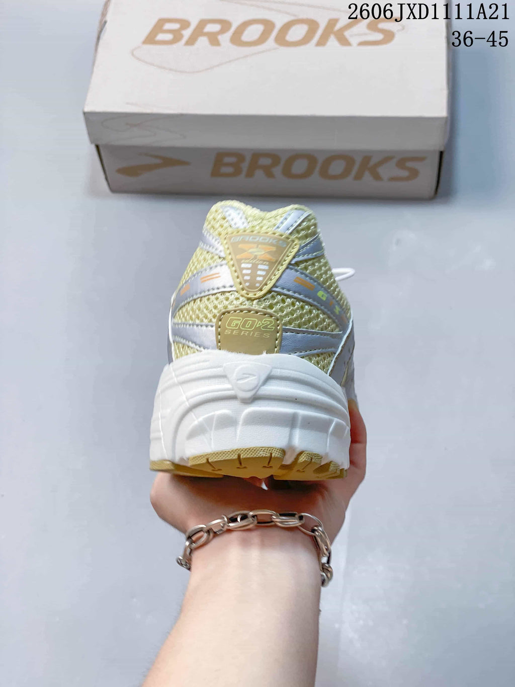 Rear view of a Brooks sneaker with a thick white heel and mesh-look upper