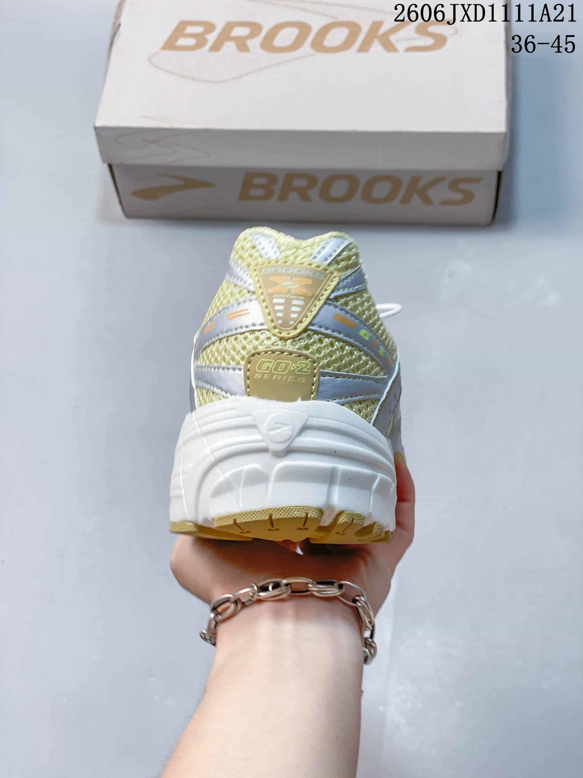 Rear view of a Brooks sneaker with a thick white heel and mesh-look upper
