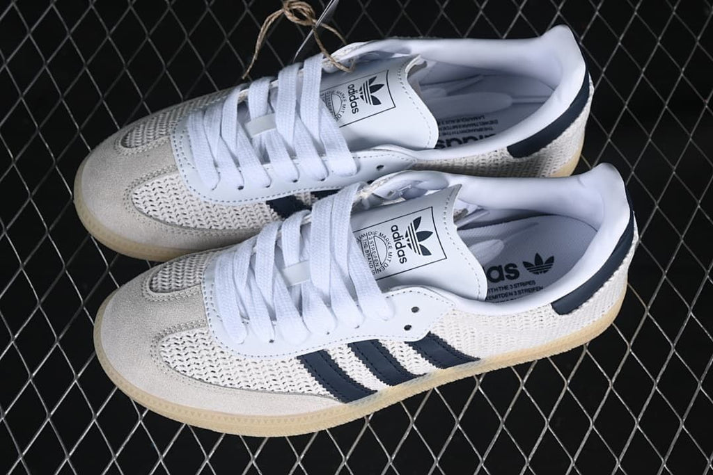Pair of white and navy adidas Samba OG sneakers viewed from above
