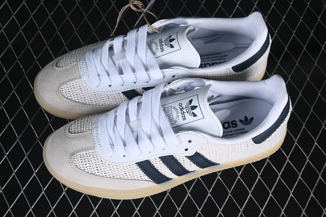 Pair of white and navy adidas Samba OG sneakers viewed from above
