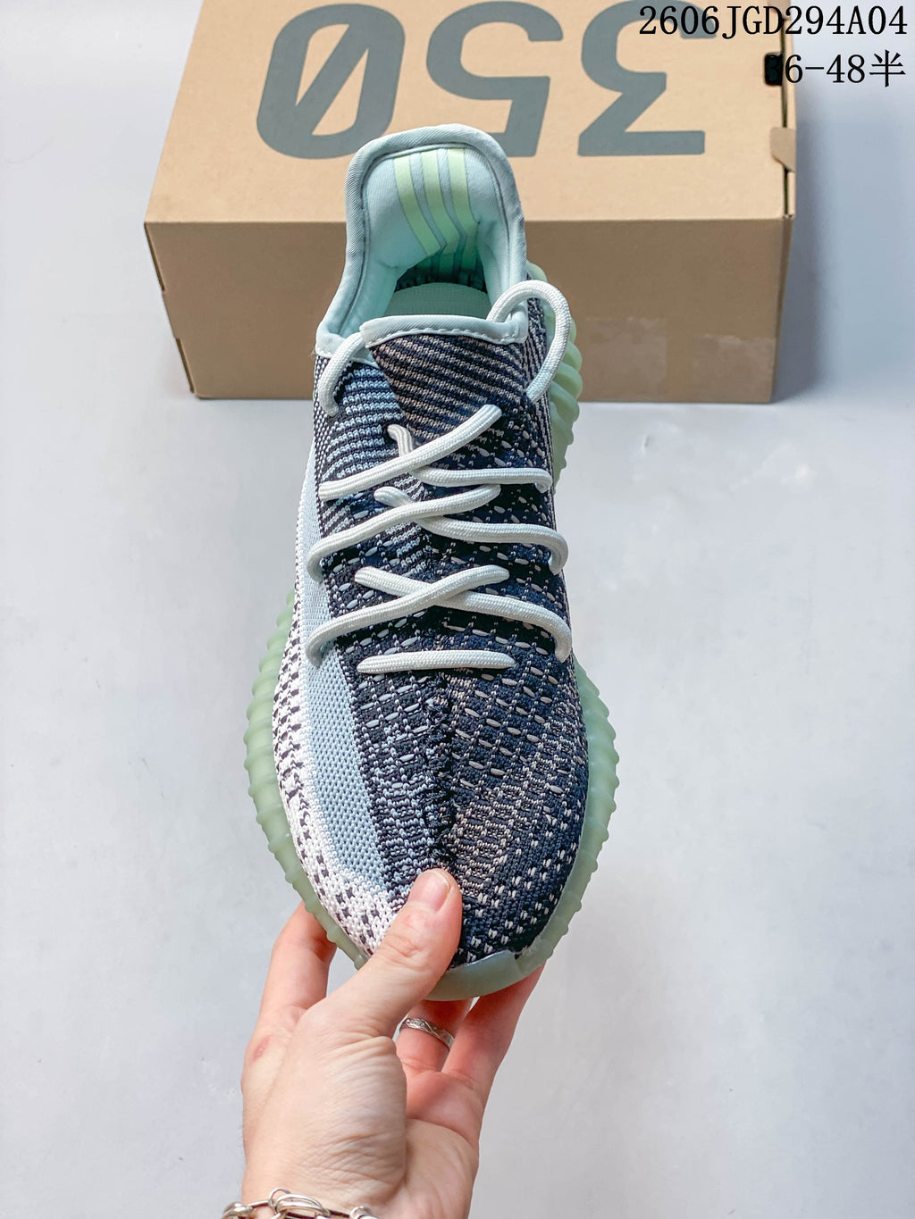 Front view showing the laces, patterned upper, and pale aqua accents
