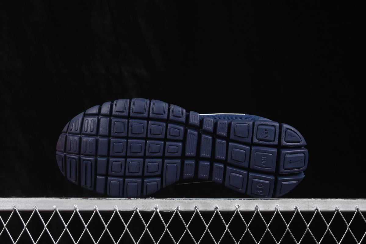 Bottom view showing the segmented navy outsole pattern and traction sections.