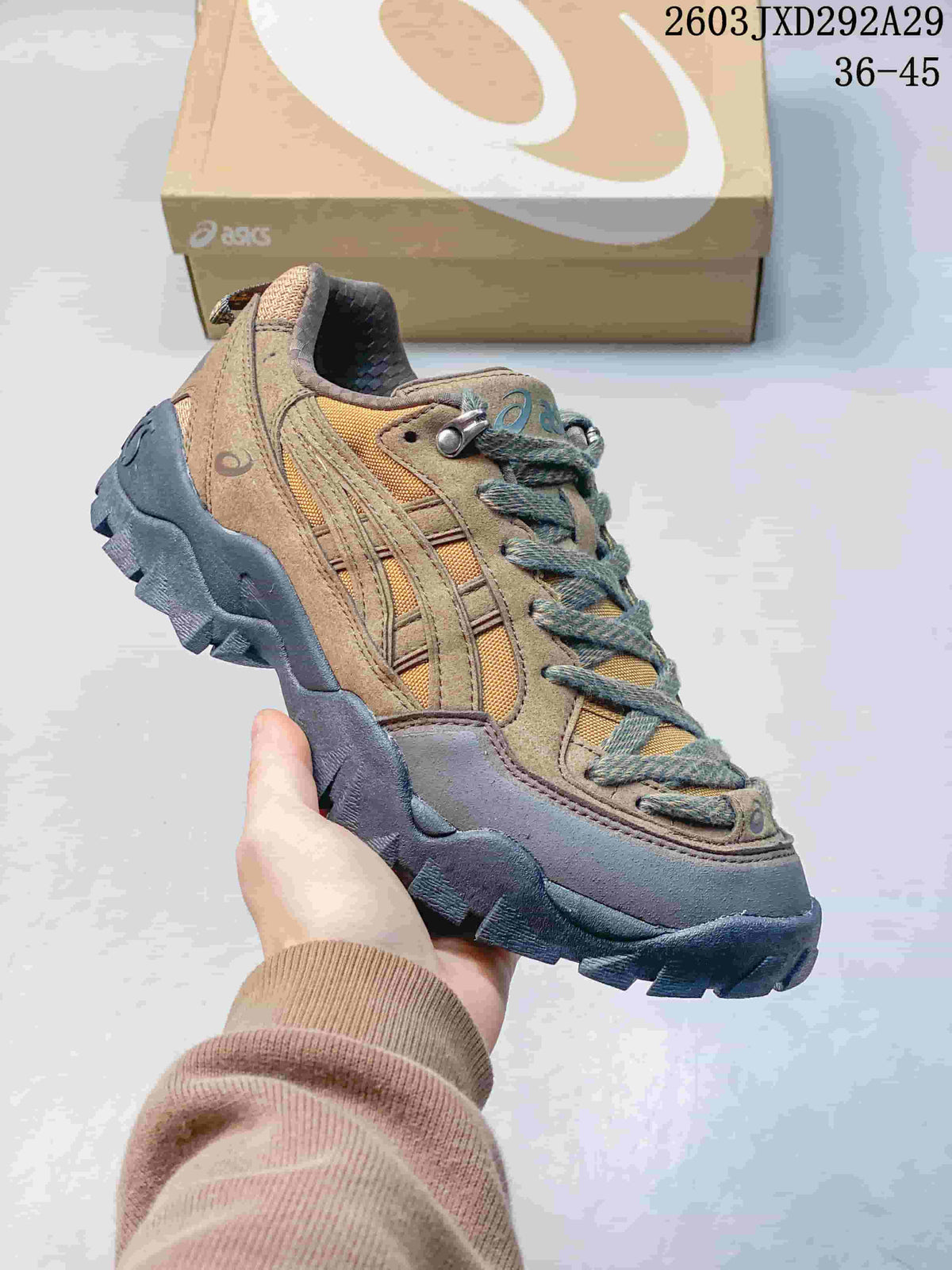 Side profile of a tan, brown, and mustard ASICS Gel-Pickax sneaker with a dark lugged sole.