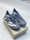 Pair of gray and white Adidas Adizero Adios Pro 4 running shoes on a box