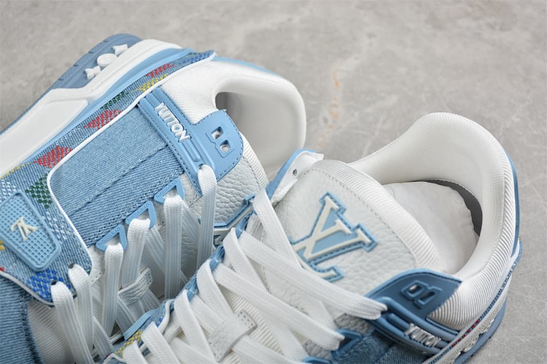 Close-up of the sneaker’s tongue, laces, and blue denim-look panels.