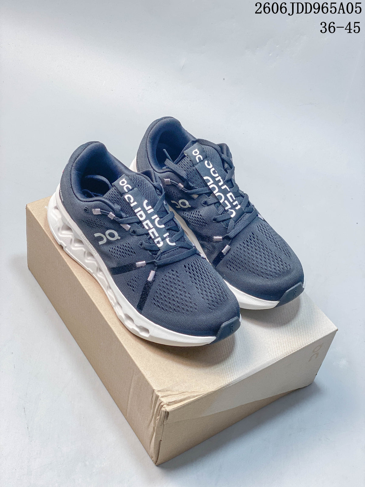 Navy On Cloudsurfer Trail shoes shown together on a box