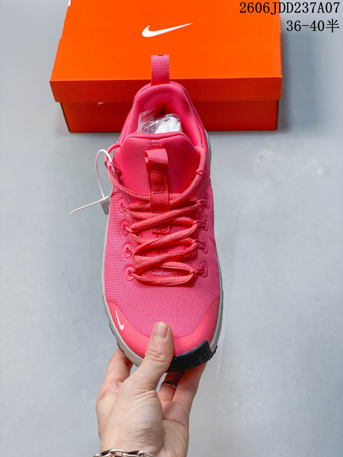 Front view showing the pink upper, laces, and pull tab.