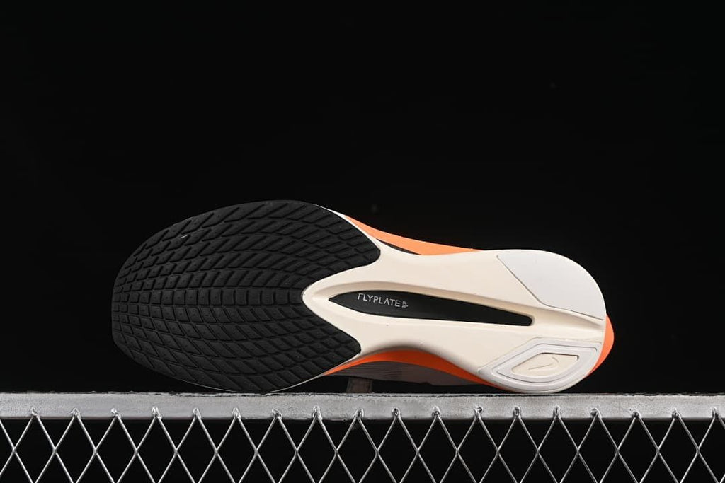 Outsole view showing black tread and a central plate area
