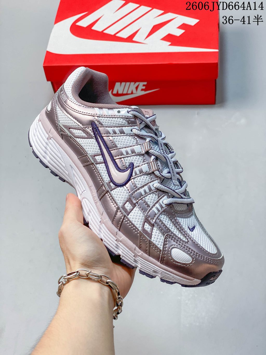 Angled view of a silver and purple Nike P-6000 sneaker