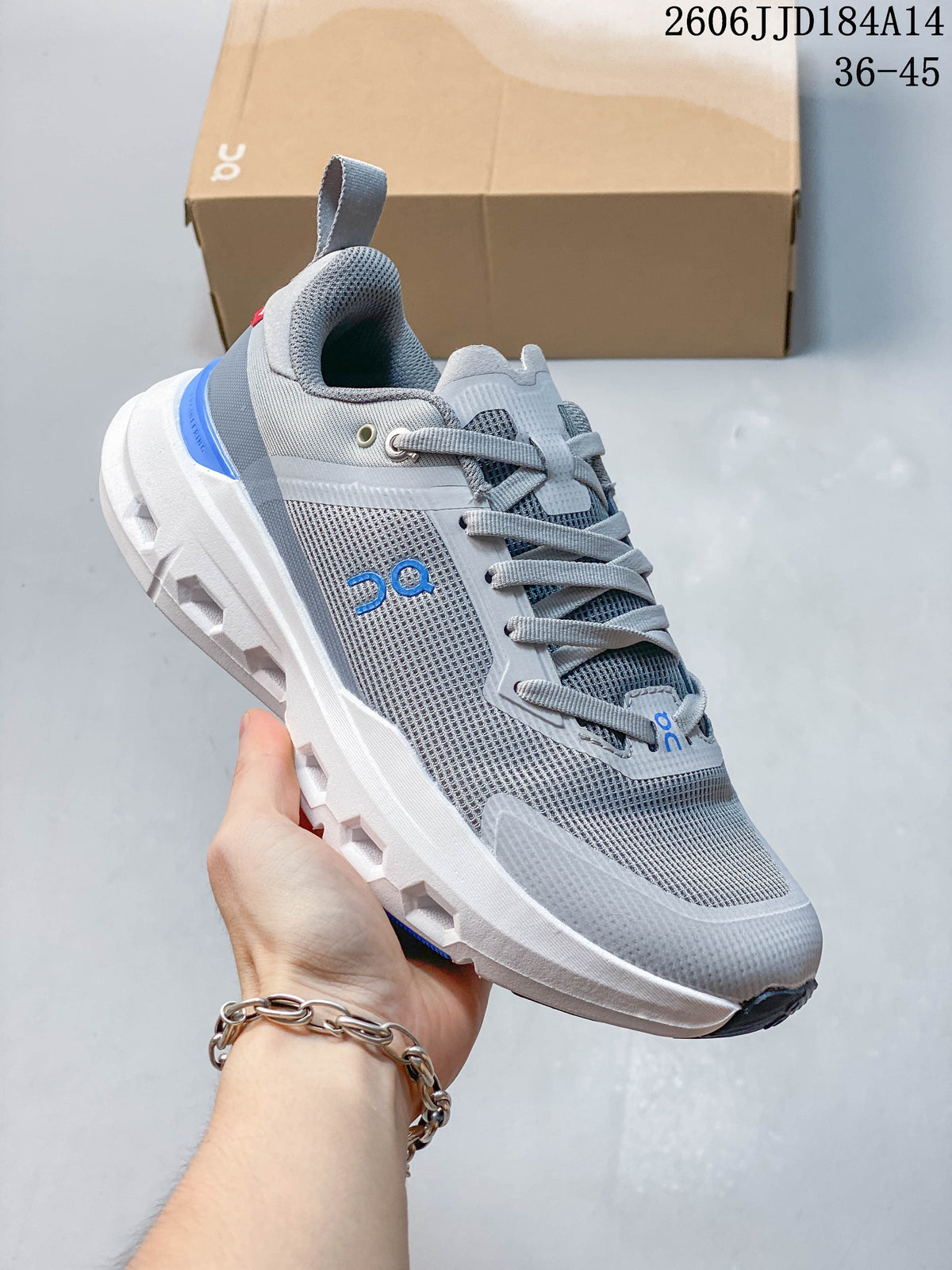 Angled side view of the gray sneaker with blue accents and sculpted sole