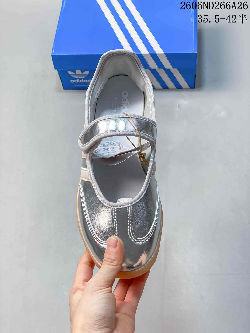 Top view of the silver Mary Jane-style sneaker and its instep strap.